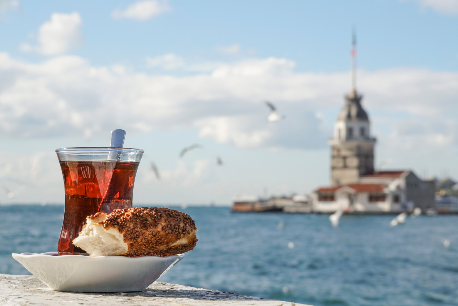 A glass of Turkish tea and bagel against sea in Istanbul, Turkey